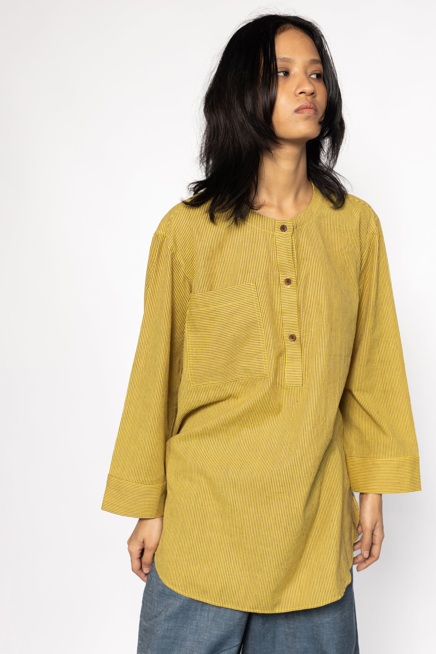 Plains Design - Harvest oversized shirt. Mustard yellow oversized shirt with brown stripes, wooden buttons, and front chest pocket, paired with blue jeans. Ethical fashion. Handmade cotton.