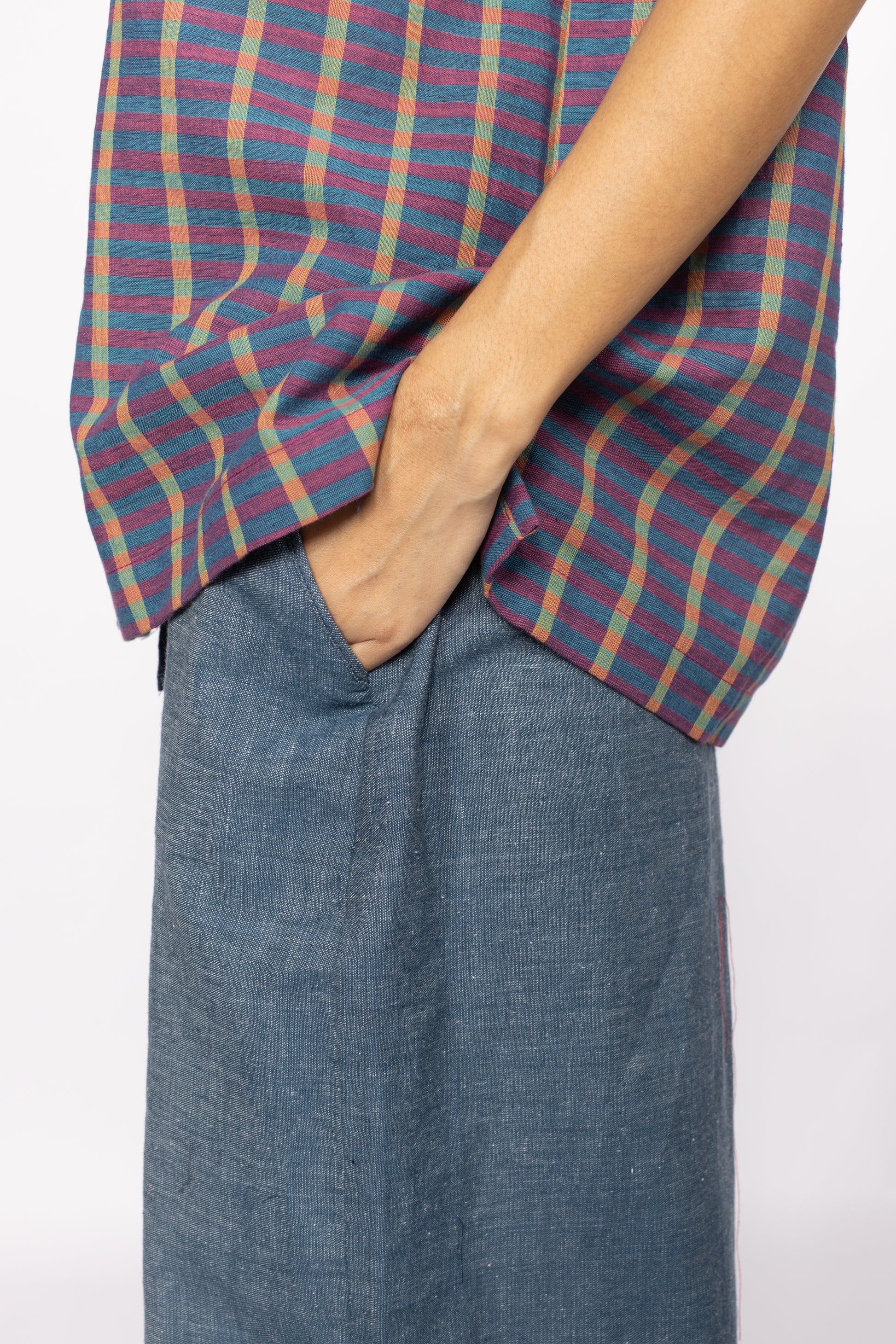 Plains Design Billie Denim Pants – close-up and side pocket detail of wide-leg handwoven cotton denim hem, styled with brown leather boots