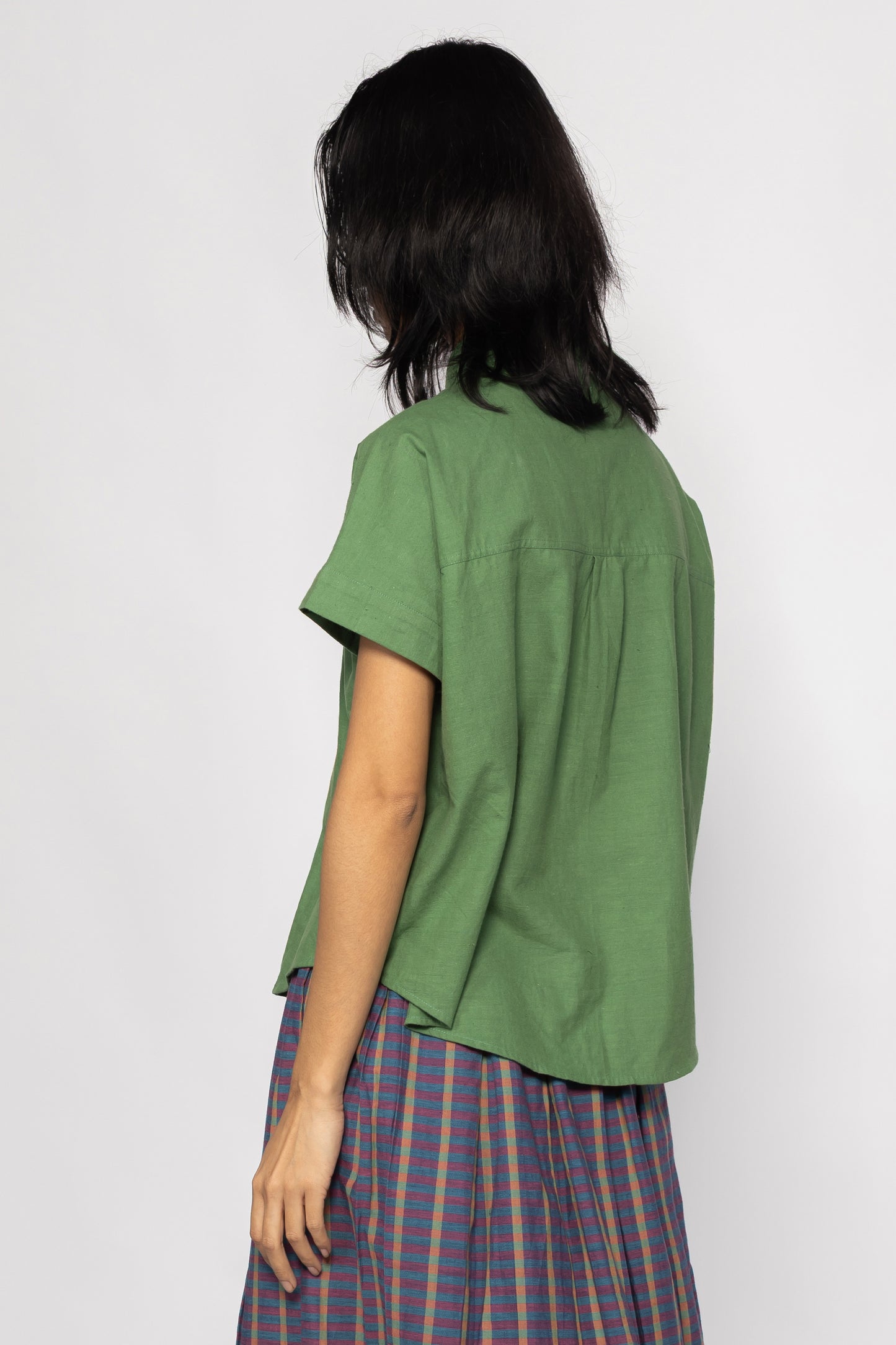 Plains Design - Bud Shirt. Back side of bright green short sleeved shirt in handwoven cotton.