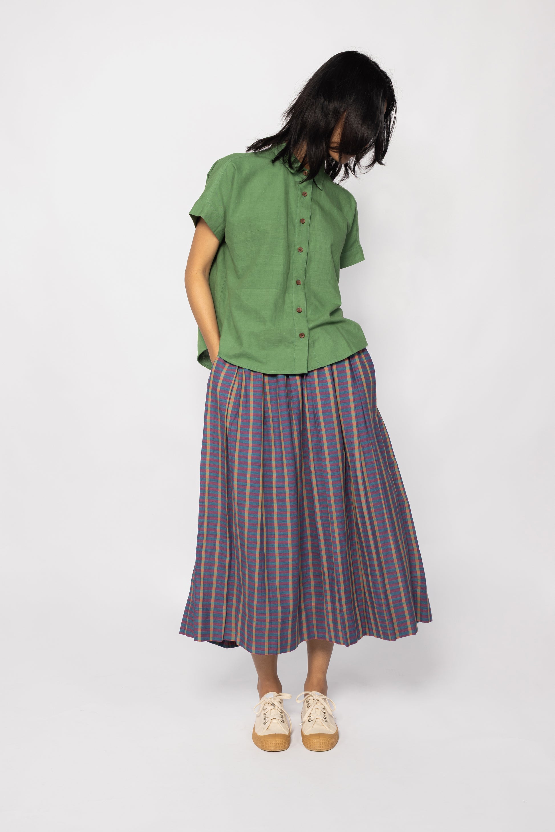 Plains Design - Twin Skirt in Purple. Purple  striped skirt with pockets paired with a green shirt and canvas shoes. Handmade cotton. Ethical fashion.