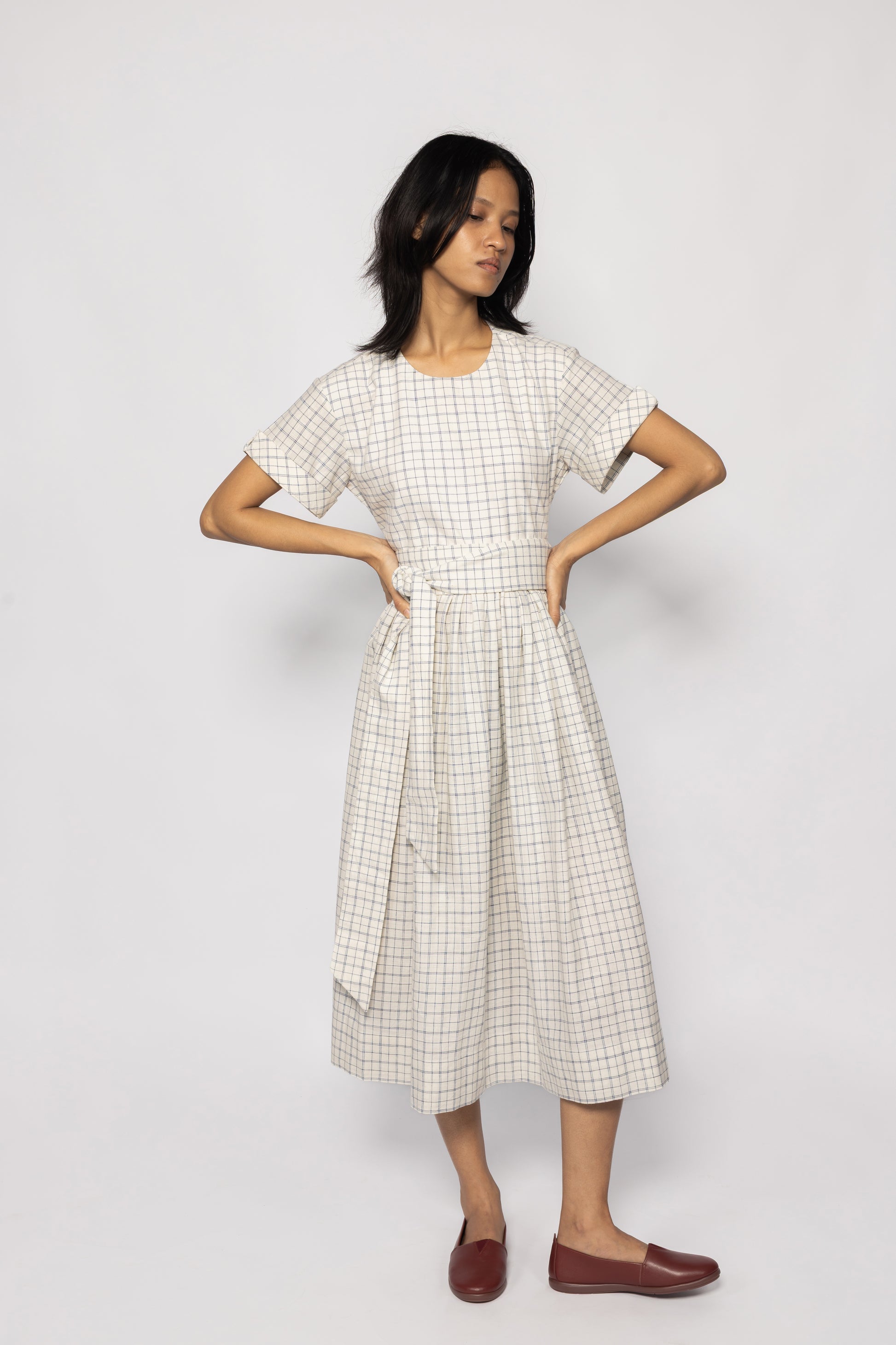 Plains Design Letter Dress - Full length front of model wearing beige checkered dress with detachable cloth belt and short sleeves. Sustainable handmade fashion.